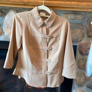 This is more like a casual jacket, more than a top.  Polyester and spandex.